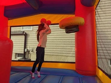 A young girl playing Basketball inside of our Combo Bounce House.