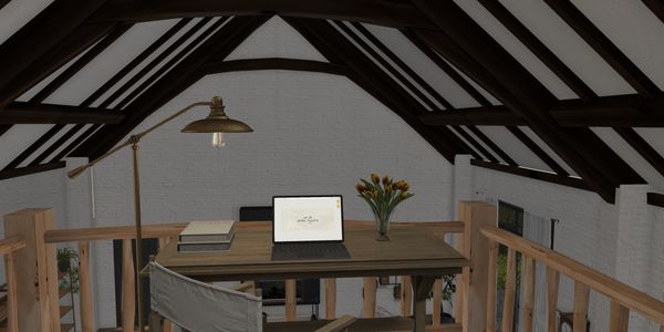 Cozy attic workspace with wooden beams, a laptop, books, and a vase of flowers.