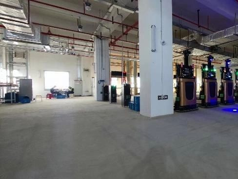 Empty industrial space with machinery and ventilation.