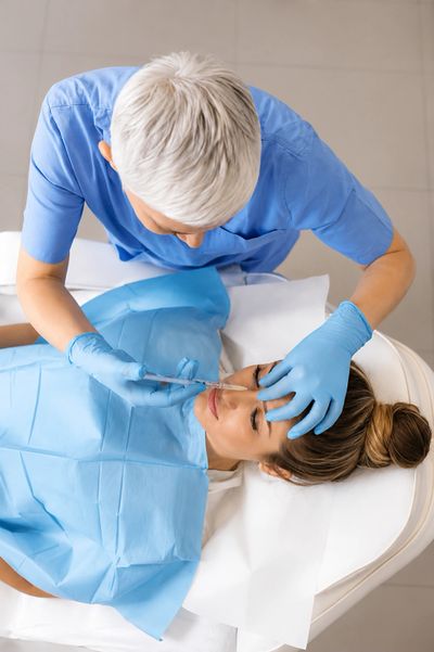 Provider performing a facial procedure.