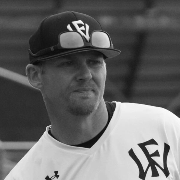 Man in baseball cap and sports jersey.