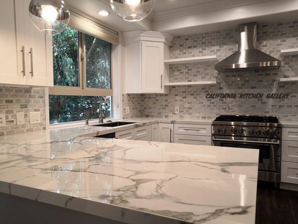 caluctta marble look counter top and white shaker cabinets 