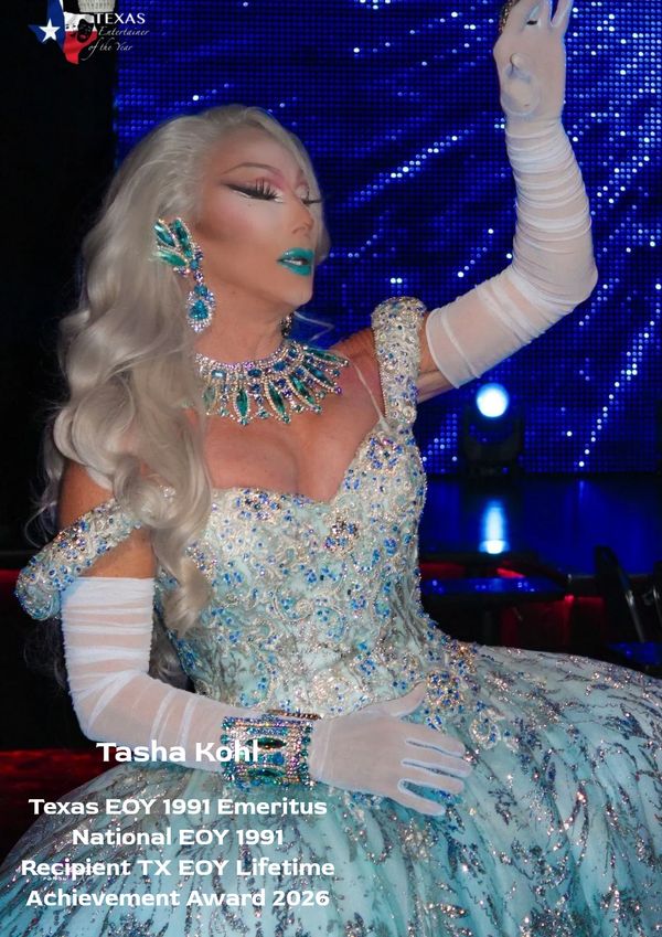 Drag performer in an ornate blue gown with gloves and jewelry.