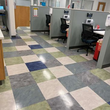 Office cubicles with patterned tile flooring.