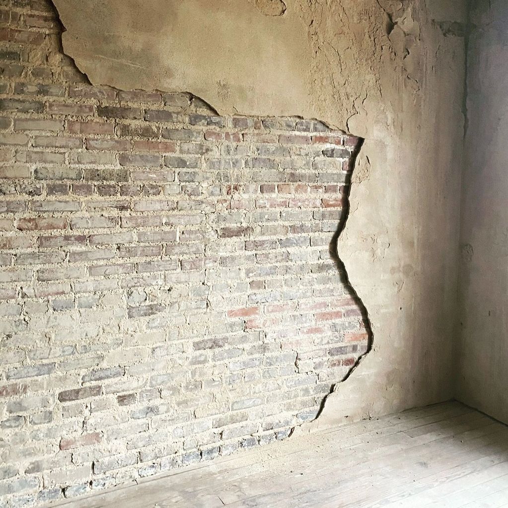 Exposed Brick behind plaster