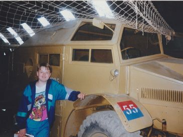 boy next to military vehicle