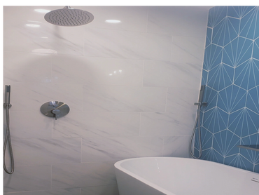 Wet room bathroom remodel with freestanding tub, walk-in rain shower, and seafoam green accent tile