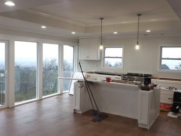 Kitchen remodel with new cabinets and a full glass wall view of the Appalachian Mountain foothills.
