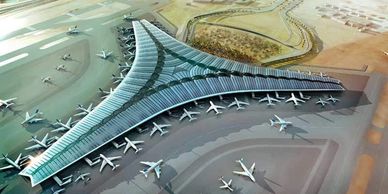 Aerial view of a large, modern airport terminal with multiple airplanes parked at gates.