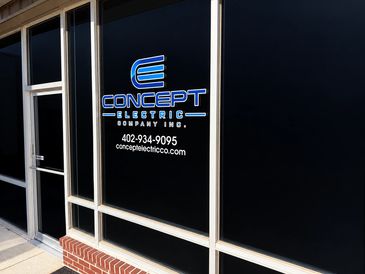 Storefront window with Concept Electric Company Inc. logo and contact info.
