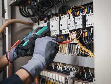 An electrical worker installing wiring in a new construction.