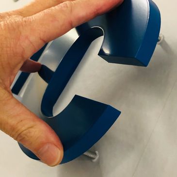 PMS painted acrylic 1/2" stud mounted dimensional logo