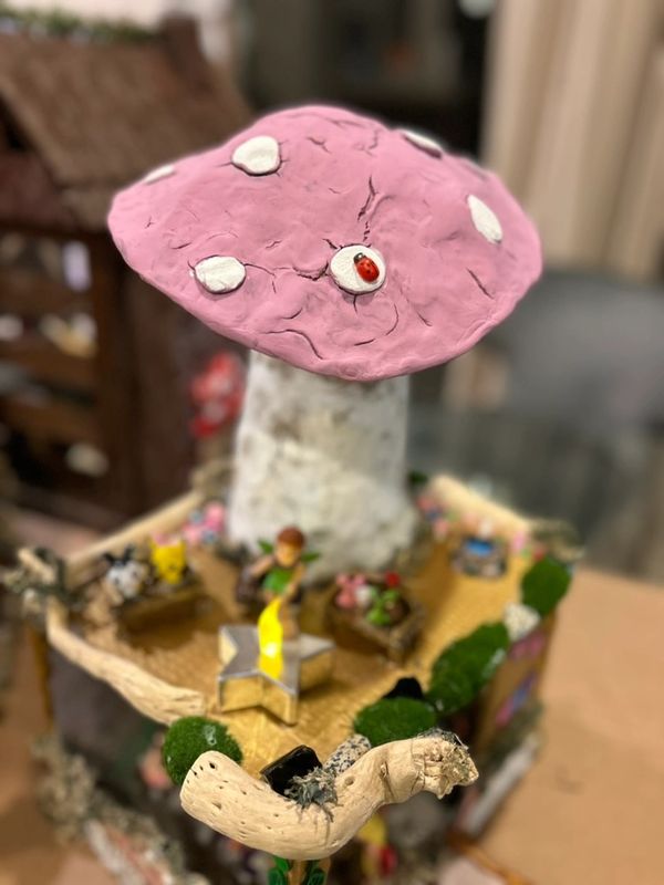 Handmade fairy cafe with a large pink mushroom on top