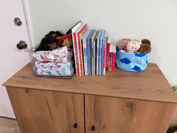 book and dolls on a counter