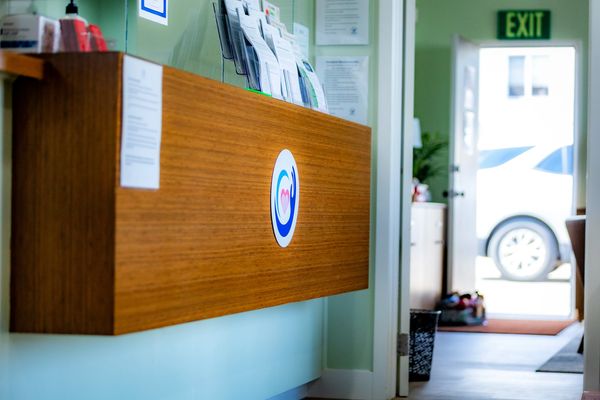 An angled photo of the reception counter at the clinic where guests will be signed in for their apoi