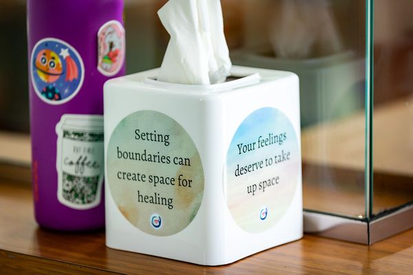 kleenex tissue box that reads "Setting boundaries can make space for healing" on one side and "Your