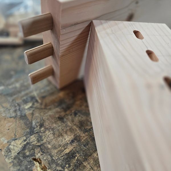 Close-up of wooden dovetail joint pieces ready for assembly.