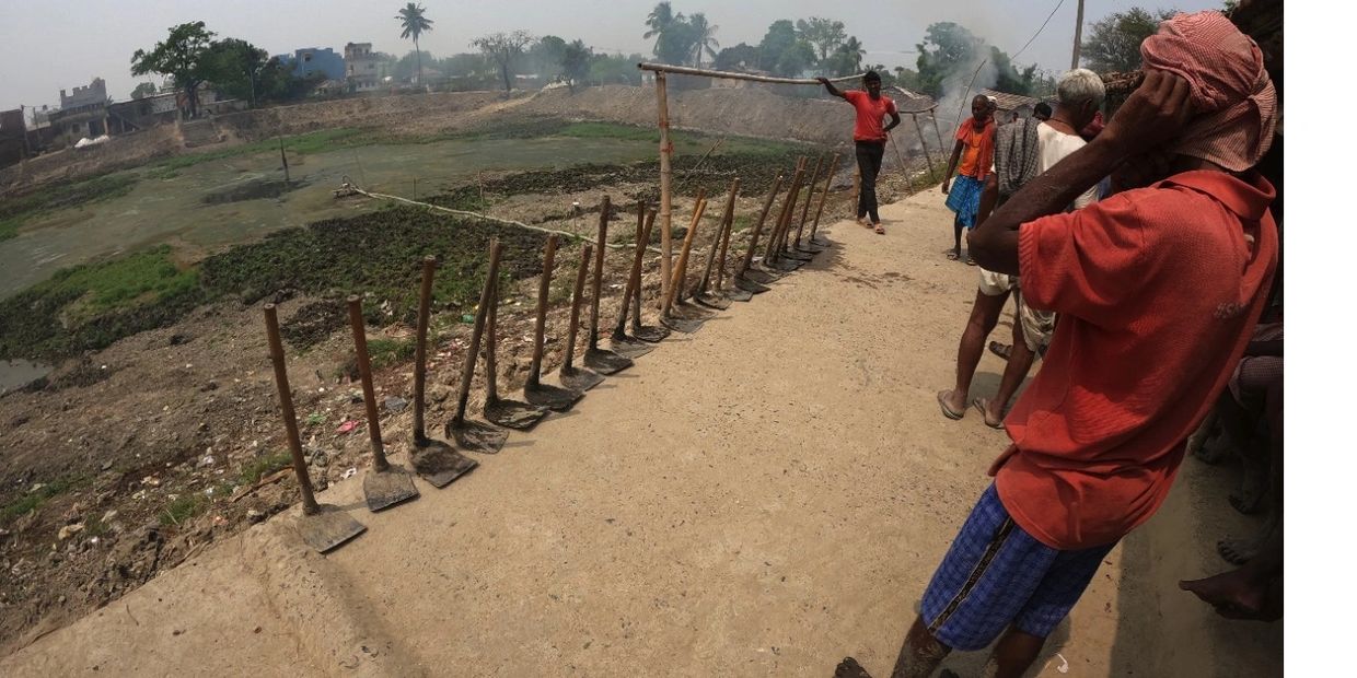 Community members beside the pond during the Darbhanga restoration initiative.
