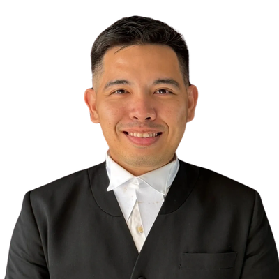Smiling man in formal attire with white shirt and black blazer.