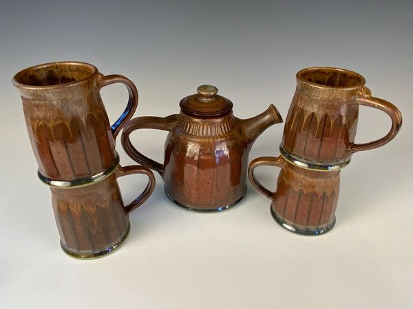 Teapot and four mugs, ketchup red glaze.
$120-teapot, mugs $28.