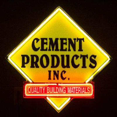 yellow diamond with cement products inc. written in black text.  Red banner with quality building ma