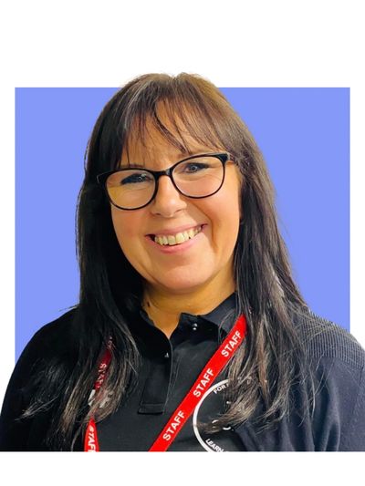 Smiling woman with glasses wearing a staff lanyard.