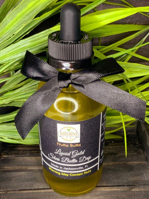 dropper bottle with black ribbon and liquid gold shea butter drip