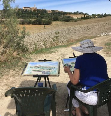 a person sitting on a chair while painting