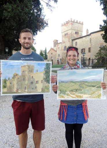 two people holding their paintings