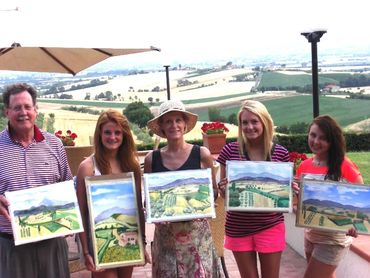 five people each holding their paintings