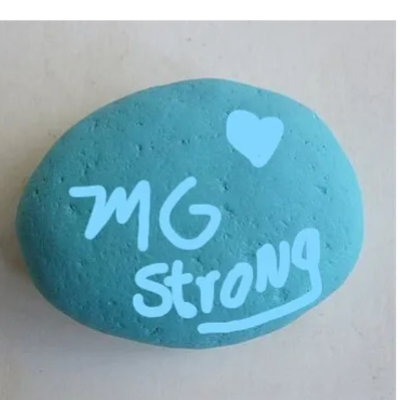 Blue painted rock with 'MG Strong' and a heart.