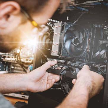 A technician replaces a component of a desktop computer