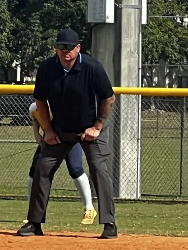 Umpire standing on a baseball field.