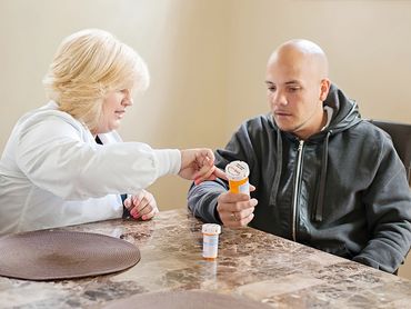 Caregiver talking with senior man.