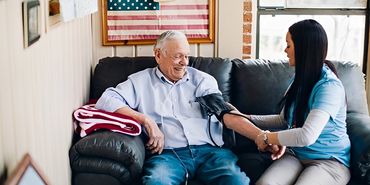 Nurse talking with elderly man