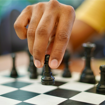 Woman moving a chess piece