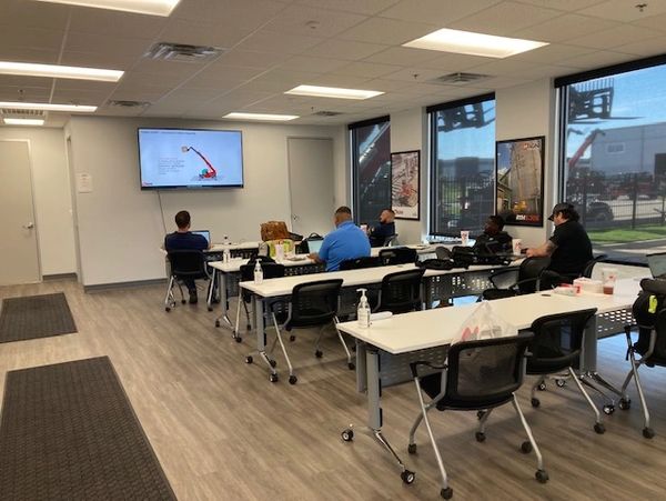 A classroom with students watching a presentation on a screen.
