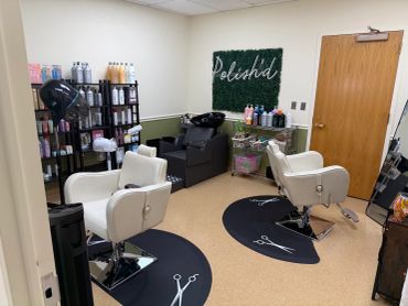 Clean and organized hair salon with styling chairs and hair products.