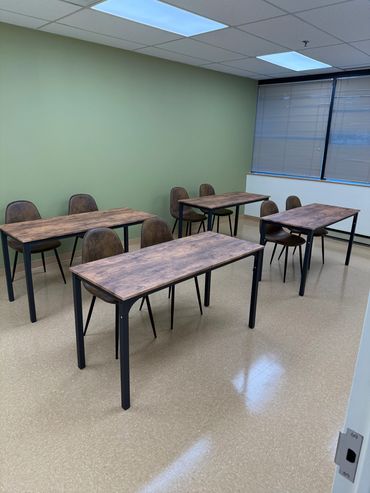 Empty classroom with tables and chairs.