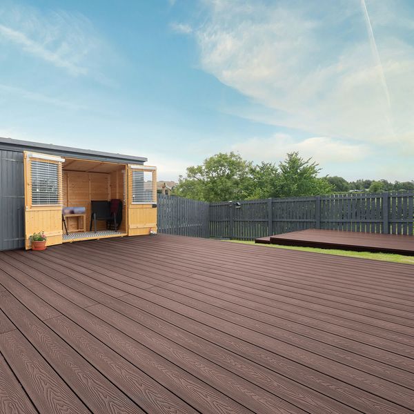 Spacious backyard with wooden deck and garden shed.