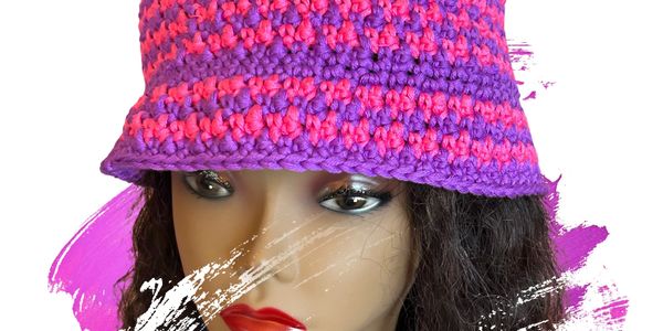 Crocheted pink and purple hat on mannequin.