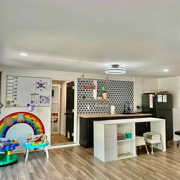 Modern kitchen with children's play area and kitchenette.