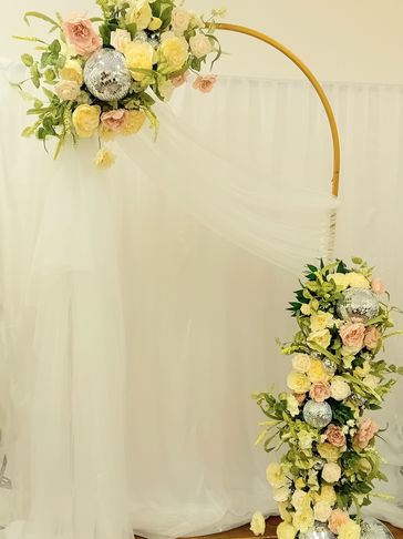 Wedding arch with florals, draping and disco balls