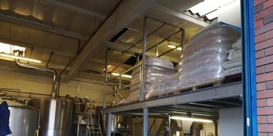 A low headroom pallet safety gate on a galvanised loading platform at a brewery in London. 