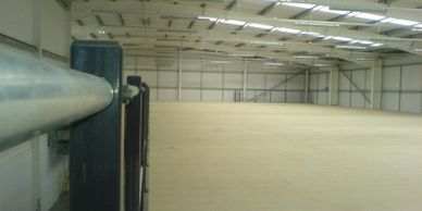A large expanse of clear mezzanine floor with double tubular handrail in a distribution warehouse. 