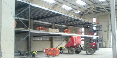 Grouting the recessed baseplates of a two storey office mezzanine floor in Berkshire.