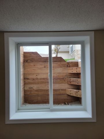 A new double egress window installation  timberwell and white trim 