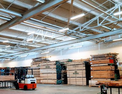 hardwood lumber overstock and order staging area with forklift