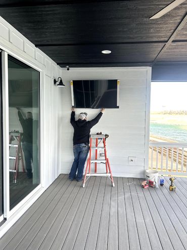 A man standing on the porch of his home