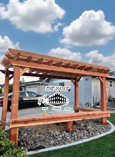 Custom Redwood pergola and outdoor seating installation in San Jose by The Wolf Fence.